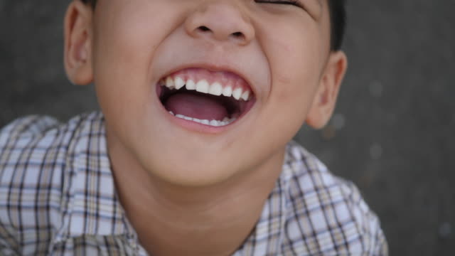 Close-up-little-boy-laughing-and-smile-after-hearing-joke-story