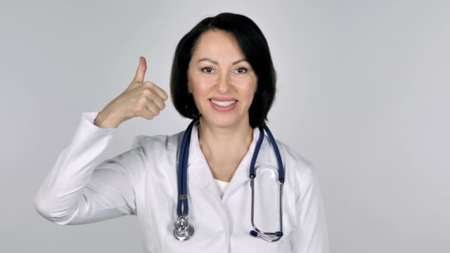 Portrait-of-Lady-Doctor-Gesturing-Thumbs-Up