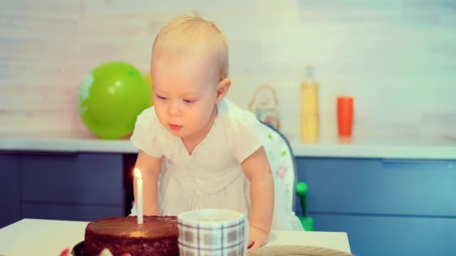 The-kid-blows-out-the-candle-on-the-cake
