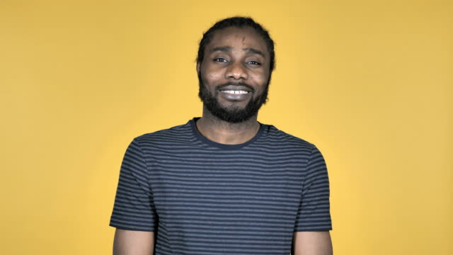 Smiling-Casual-African-Man-Isolated-on-Yellow-Background