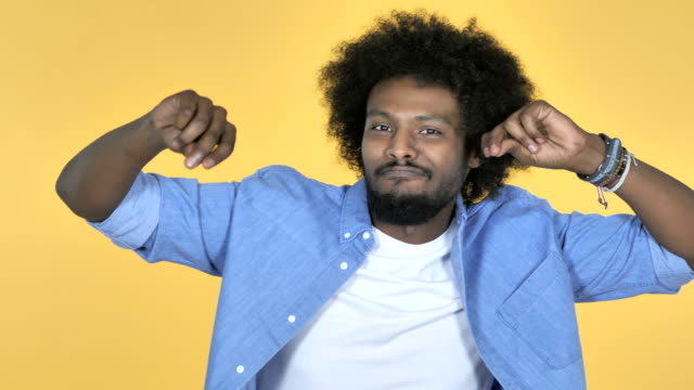 Excited-Afro-American-Man-Dancing-on-Yellow-Background
