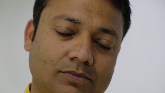 Close-up-of-an-Indian-man-looking-at-camera-in-a-sombre-mood