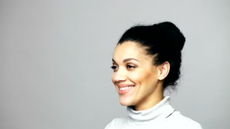 Closeup-of-young-mixed-race-woman-looking-at-camera-smiling