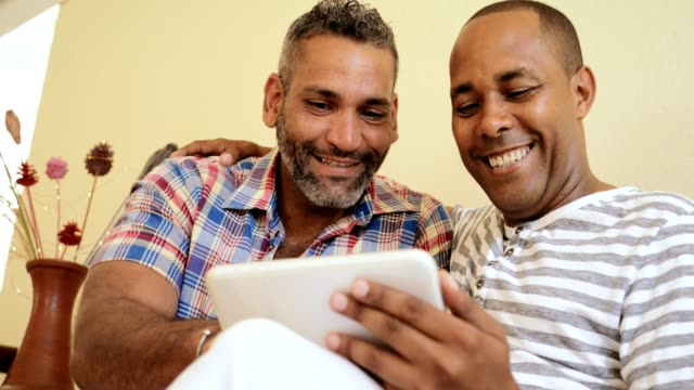 Happy-Gay-Couple-Homosexual-People-Men-Kissing-And-Using-Computer