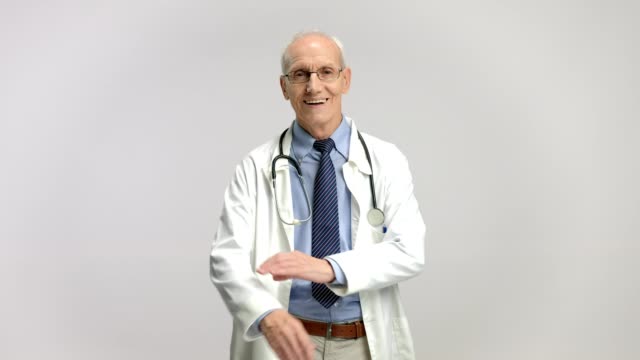 Elderly-doctor-smiling-and-crossing-his-arms