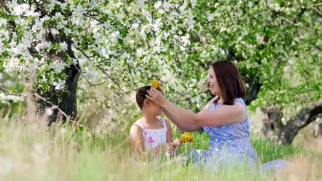 Mom-and-daughter-are-weaving-wreaths-from-flowers