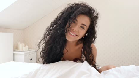 Cute-brunette-posing-for-camera-in-bed