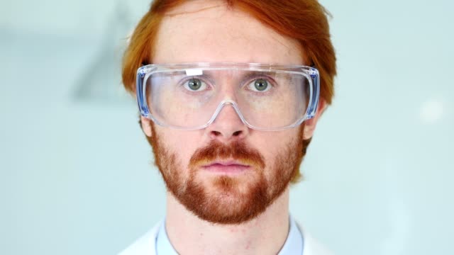 Close-Up-of-Redhead-Reseach-Scientist,-Doctor-Wearing-Protective-Glasses