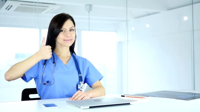 Thumbs-Up-by-Positive-Doctor-in-Clinic-toward-Camera