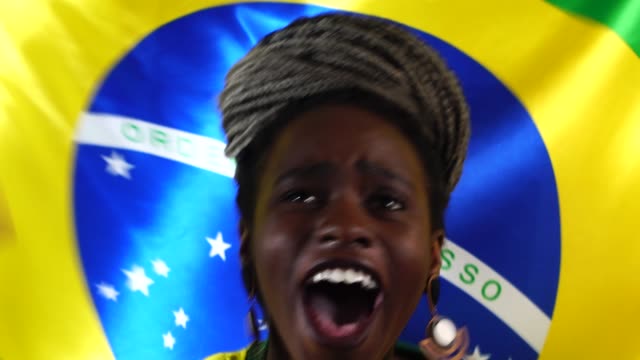 Brasilianische-junge-schwarze-Frau-feiert-mit-Brasilien-Flagge