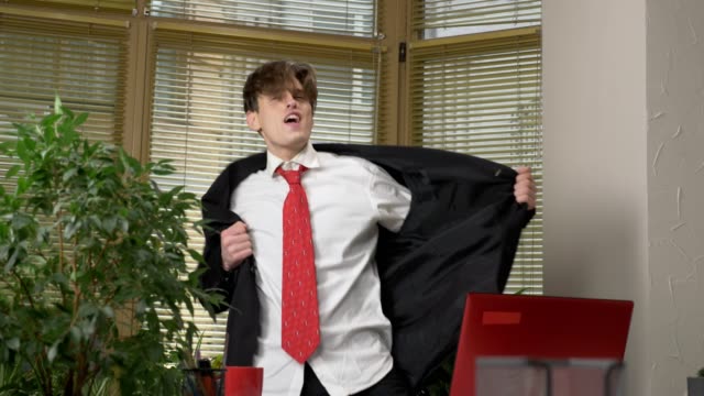 Young-man-in-a-suit-dances-in-the-office,-makes-funny-faces,-fools-around,-rejoices.-Work-in-the-office-concept-60-fps