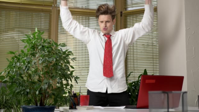 Young-man-in-a-suit-dances-in-the-office,-makes-funny-faces,-fools-around,-rejoices.-Work-in-the-office-concept-60-fps