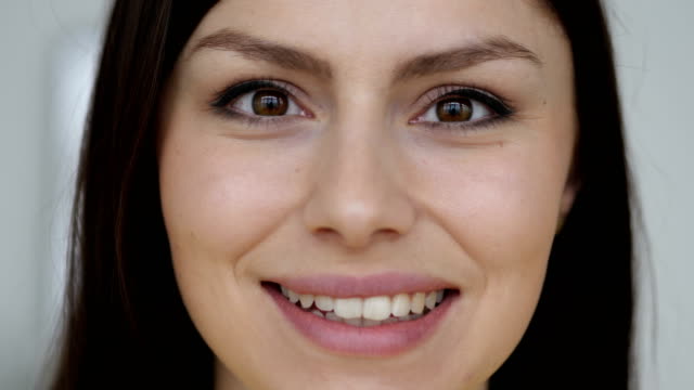 Close-Up-of-Smiling-Face-of-Young-Woman-Looking-at-Camera