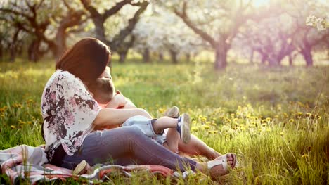 Beautiful-mother-and-her-little-daughter-and-son-outdoors