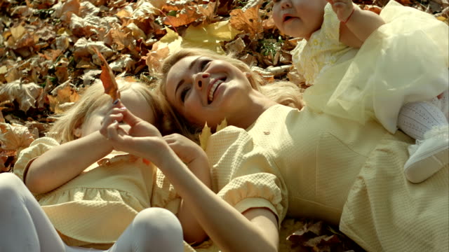 Familia-feliz-madre-en-otoño-parque-y-los-niños