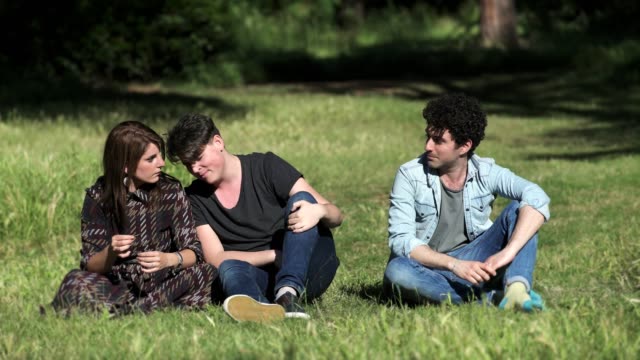 funny-guy-sings-on-the-lawn-while-his-friends-looking-at-him