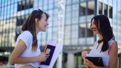 Young-creative-business-team.-Two-attractive-female-financial-traders-are-working-together-on-an-statistics-on-paper-near-business-office