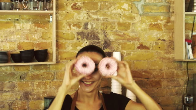 Coffeeshop-worker-have-fun-with-donats.