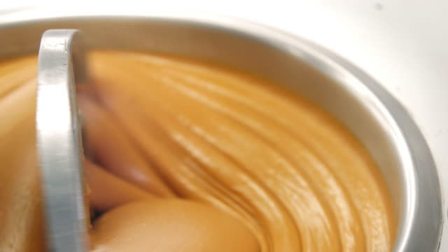 Close-up-shot-of-tasty-peanut-butter-in-industrial-mixer