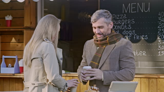 Man-and-woman-drink-coffee-outdoor-coffee-shop