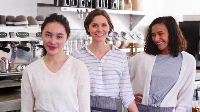 Three-female-business-owners-behind-the-counter-at-cafe
