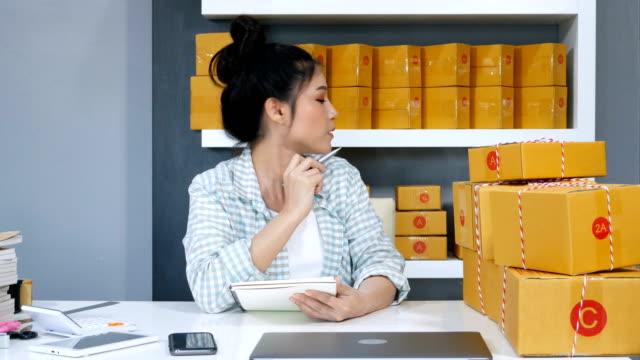 junge-Frau-Unternehmer-zählen-Paket-Boxen-in-ihrem-eigenen-Job-Online-Geschäft-zu-Hause-einkaufen