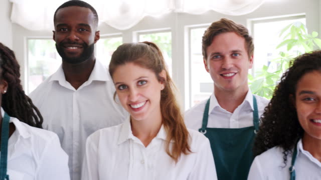 Portrait-Of-Restaurant-Management-And-Staff-Standing-In-A-Line