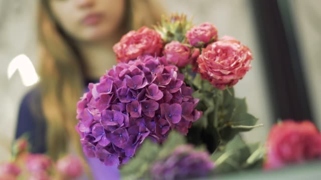 Cute-florist-picking-flowers-in-a-bouquet.-Florist-preparing-flower-bouquet.