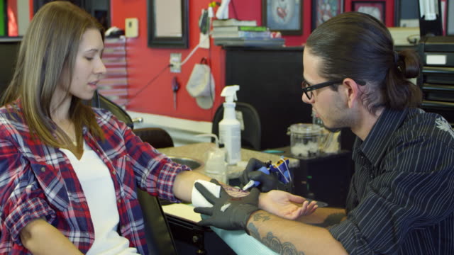 Woman-Sits-In-Chair-Having-Tattoo-In-Parlor-Shot-On-R3D