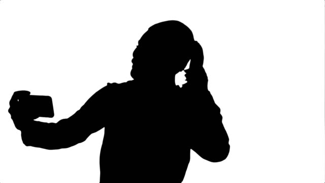 Silhouette-Businesswoman-taking-funny-selfie-with-phone