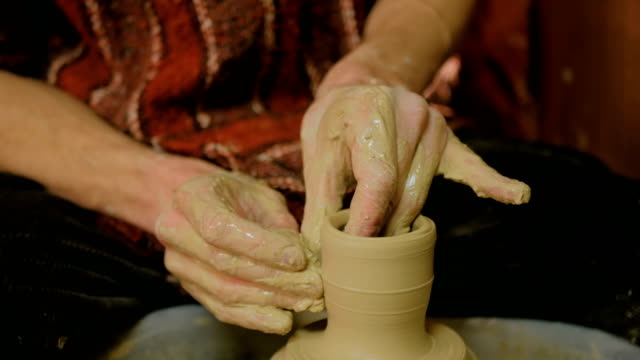 Professional-male-potter-working-in-workshop
