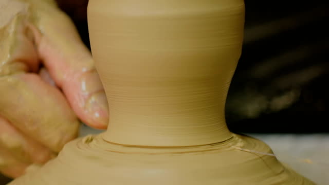 Professional-male-potter-working-in-workshop,-studio