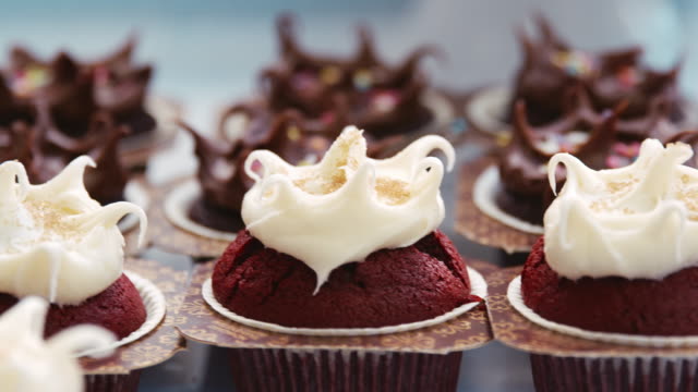 Close-up-of-frosted-chocolate-and-red-velvet-muffins