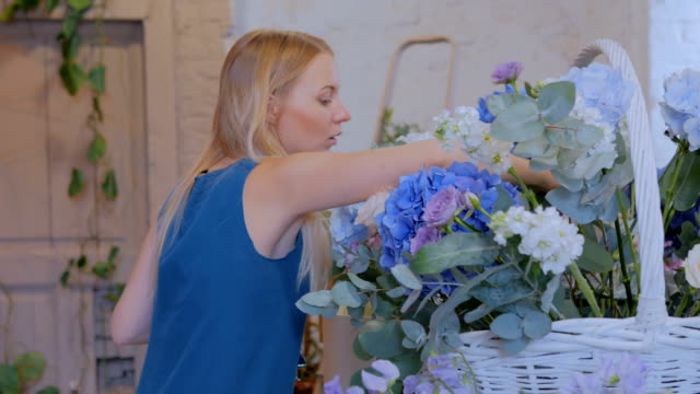 Floristen-machen-große-Blumenkorb-mit-Blumen-im-Blumenladen