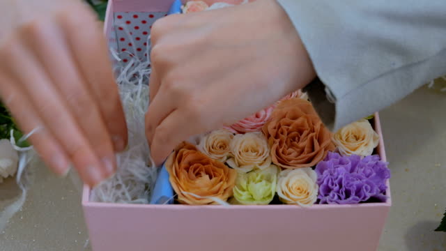 Professionellen-Floristen-machen-Geschenkbox-mit-Blumen-im-Blumenladen