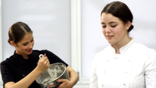 Beautiful-young-female-chef-smiling-to-the-camera-at-the-kithchen