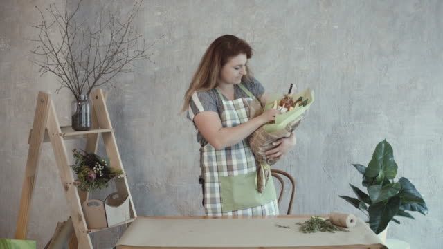 Woman-decorating-edible-arrangement-with-herbs