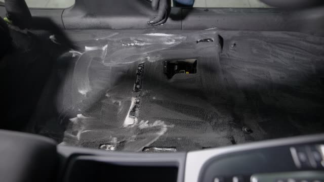 Faceless-employee-cleaning-car-interior