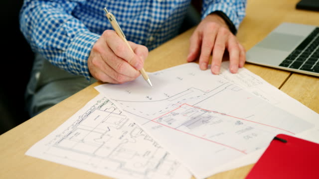 Architect-Is-Sketching-On-House-Plans-In-His-Studio