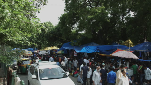 Locked-on-shot-of-people-at-market-stall,-Delhi,-India