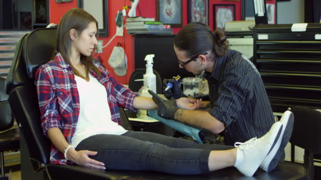Mujer-se-encuentra-en-el-sillón-con-el-tatuaje-en-la-sala-de-estar-en-el-escalofriante-R3D
