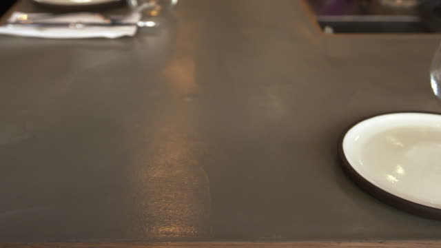 Empty-place-setting-at-a-restaurant-bar,-camera-slider-shot