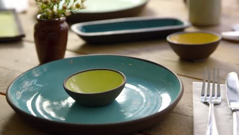 Handmade-earthenware-on-restaurant-table,-camera-slider-shot