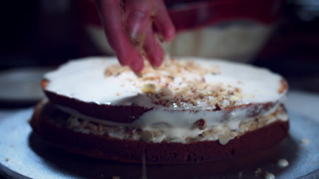 4K-Cake-Baker-Adding-Nuts-to-Baked-Sponge-and-Cream