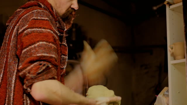 Professional-male-potter-preparing-clay-for-work