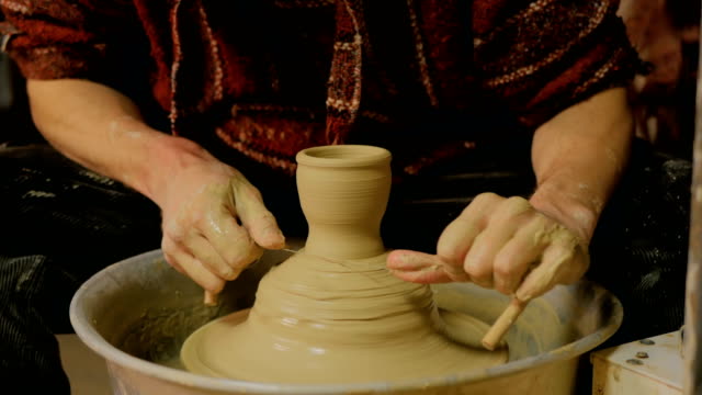 Professional-male-potter-working-in-workshop,-studio