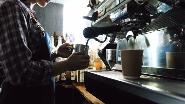 Barista-steaming-milk-for-coffee-drink