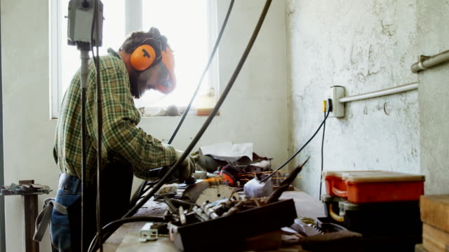 Craftsman-working-at-workshop-4k