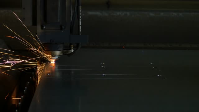 Laser-cut-machine-while-cutting-the-sheet-metal-with-sparks-and-high-precision