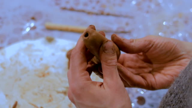 Professional-potter-making-ceramic-tobacco-pipe